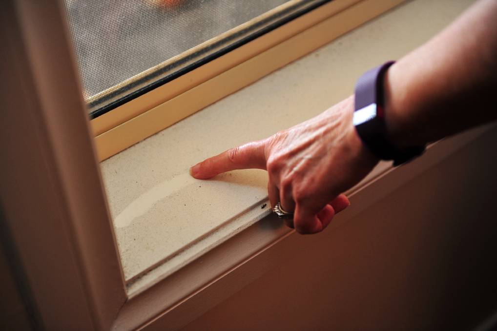 A Latrobe Valley resident wipes toxic coal dust from their windowsill.